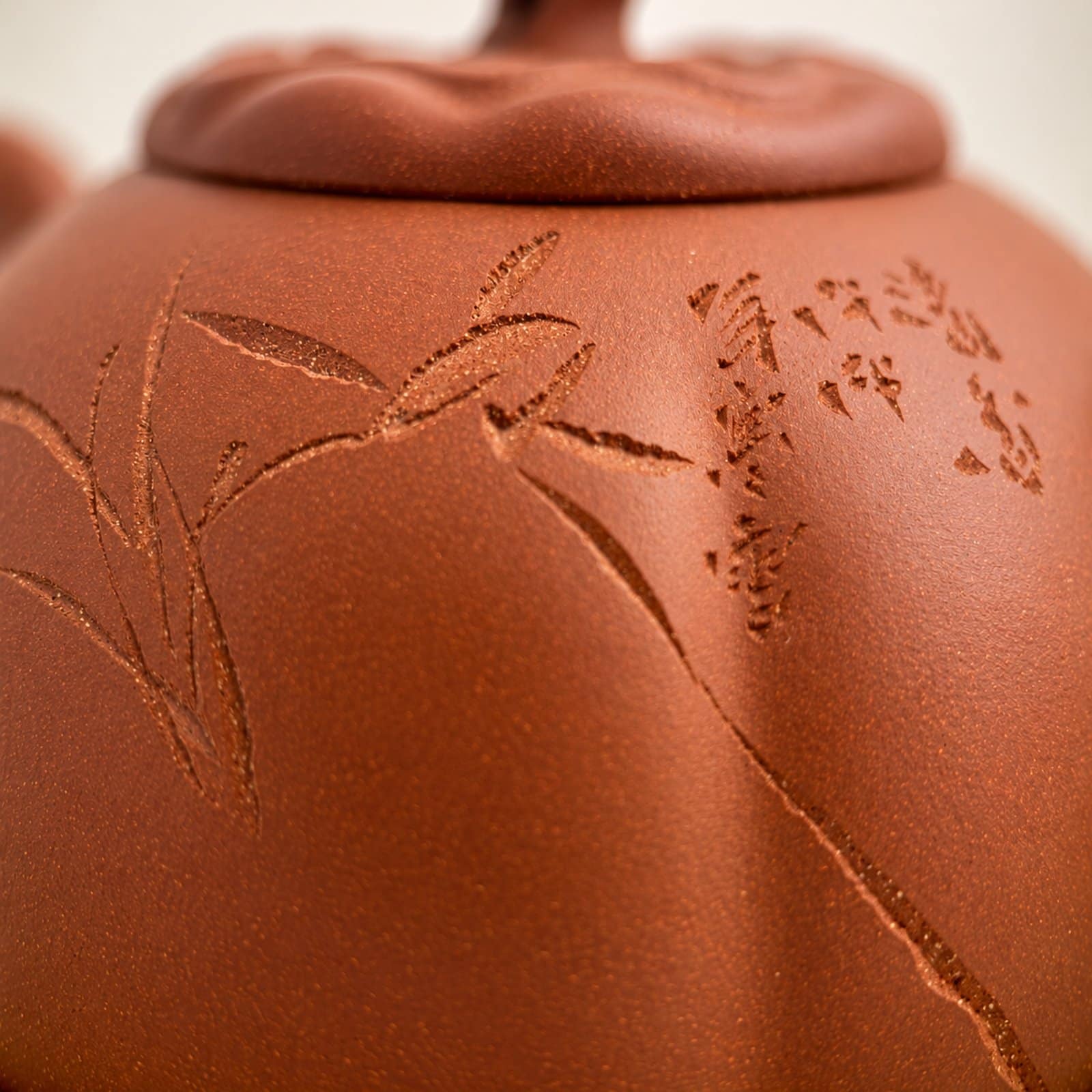 Tea Ware, Made by Hand Close view of bamboo-like incisions on a reddish-brown teapot.
